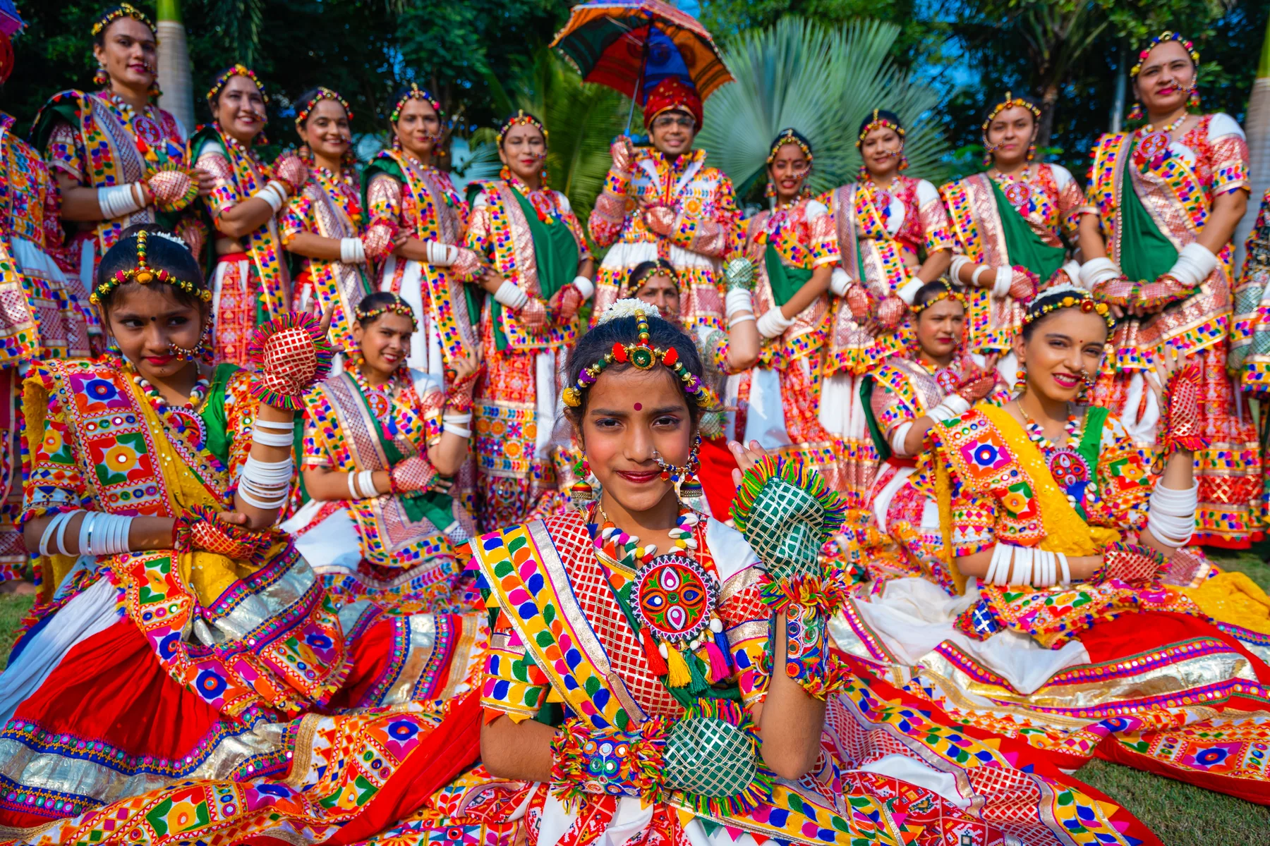 Garba dancers in jewel-toned traditional costumes